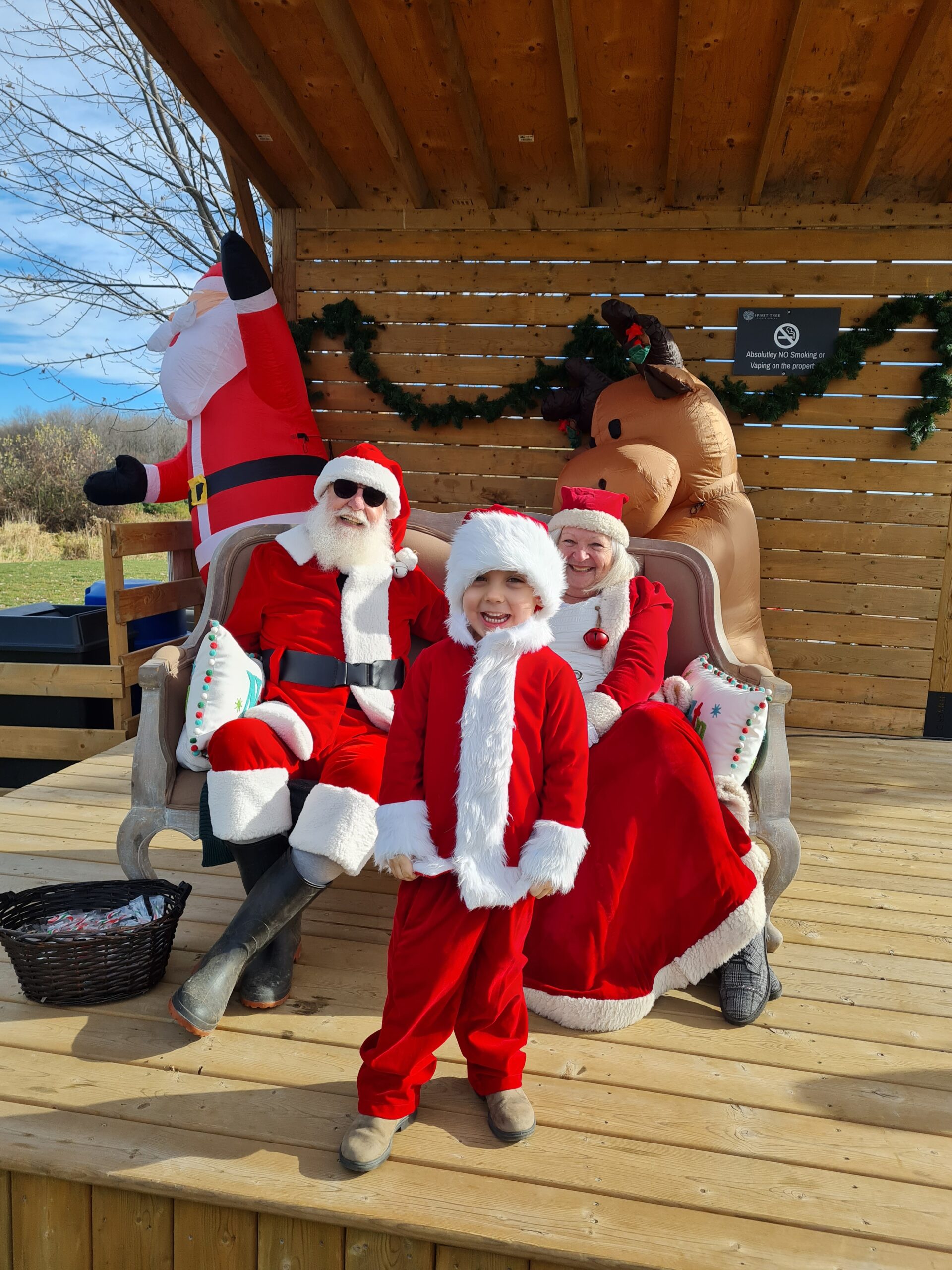 Santa, Mrs Claus and a little boy dressed up as Santa